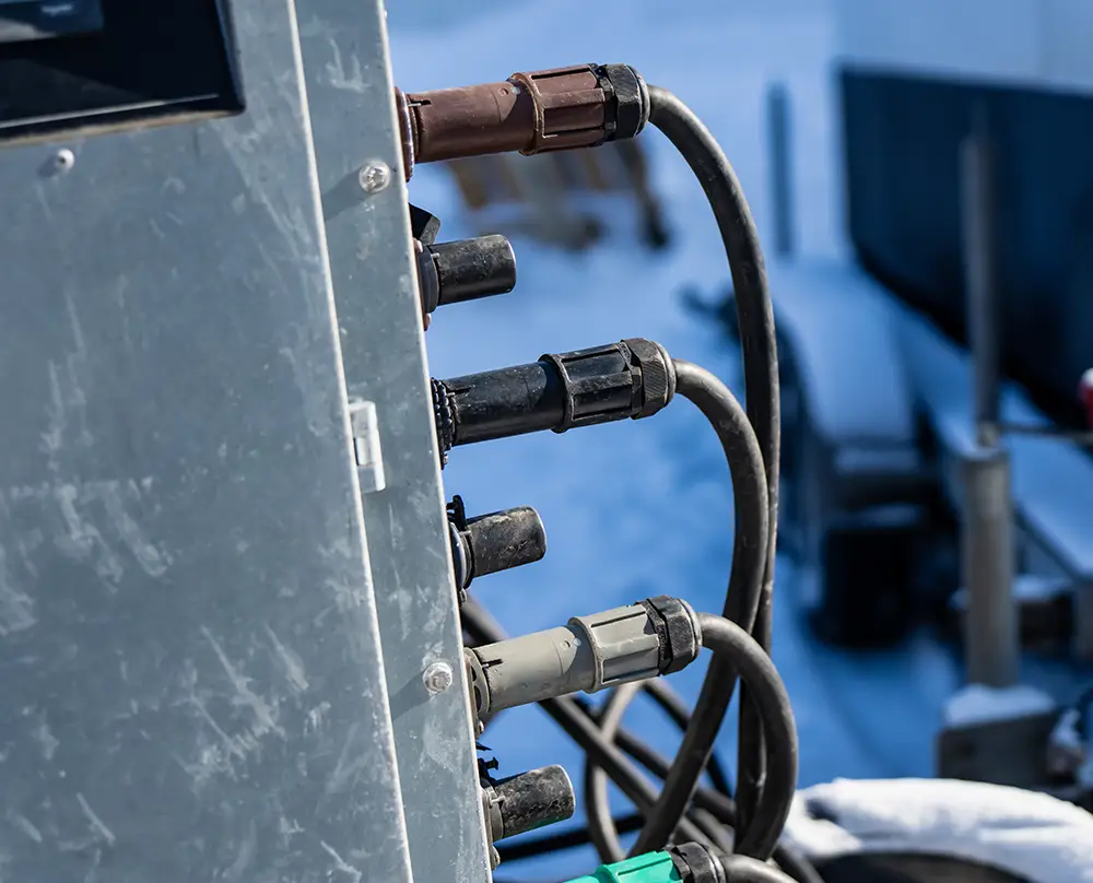 Close-up of heavy-duty electrical cables connected to industrial equipment in Belleville, IL and the Metro East.