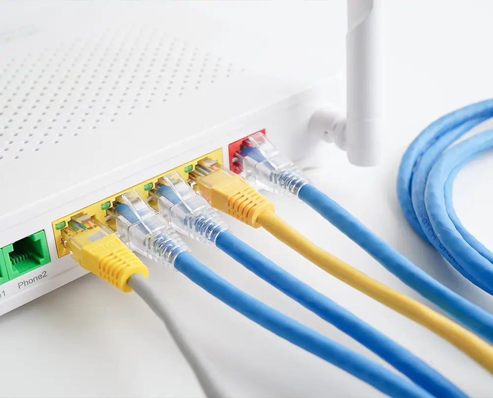 Ethernet cables connected to a router for data and internet connectivity in Belleville, IL.